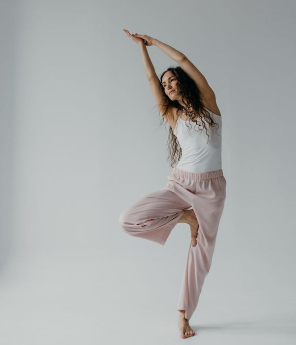 Person doing a graceful yoga flow in a minimalist room.