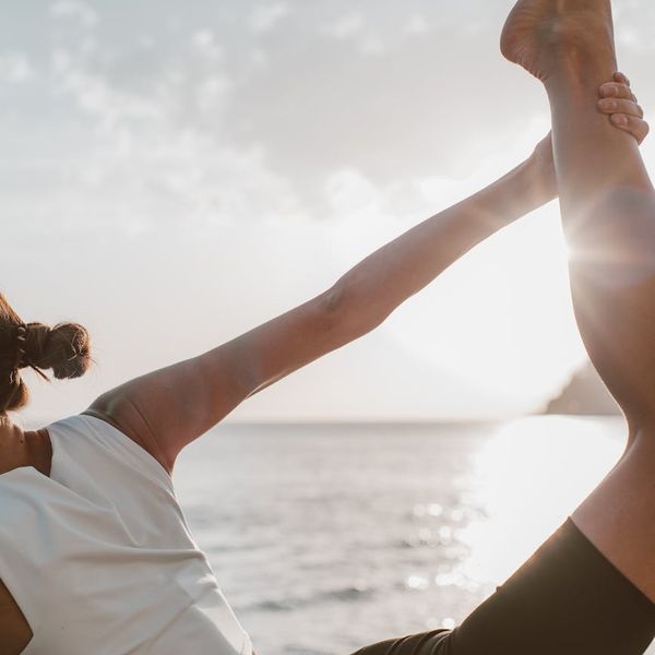 Woman in a calm yoga pose inside a warm glowing circle.